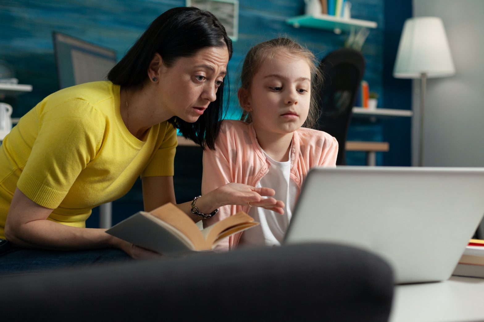 Mother and daughter doing homework for online school