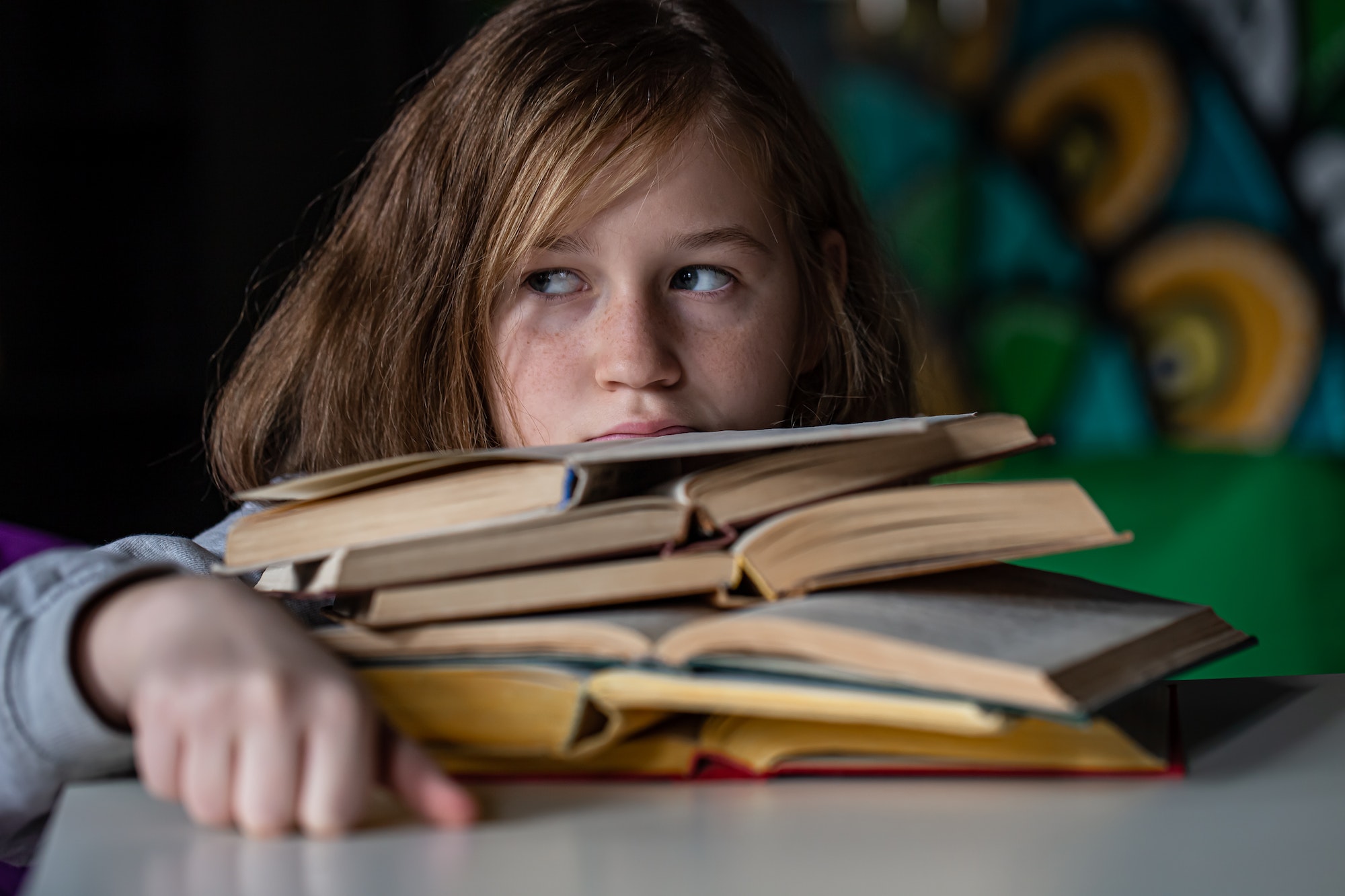 Portrait of a little girl with a book, a child reads a book.