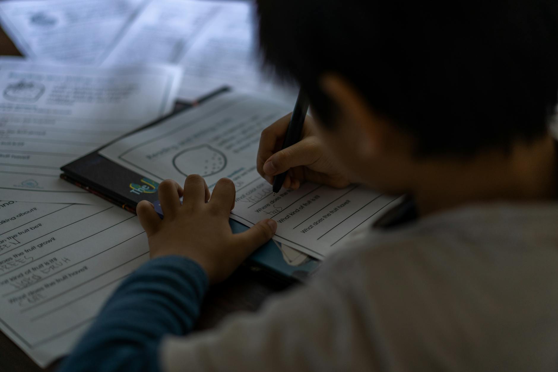 shallow focus of a child doing his homework